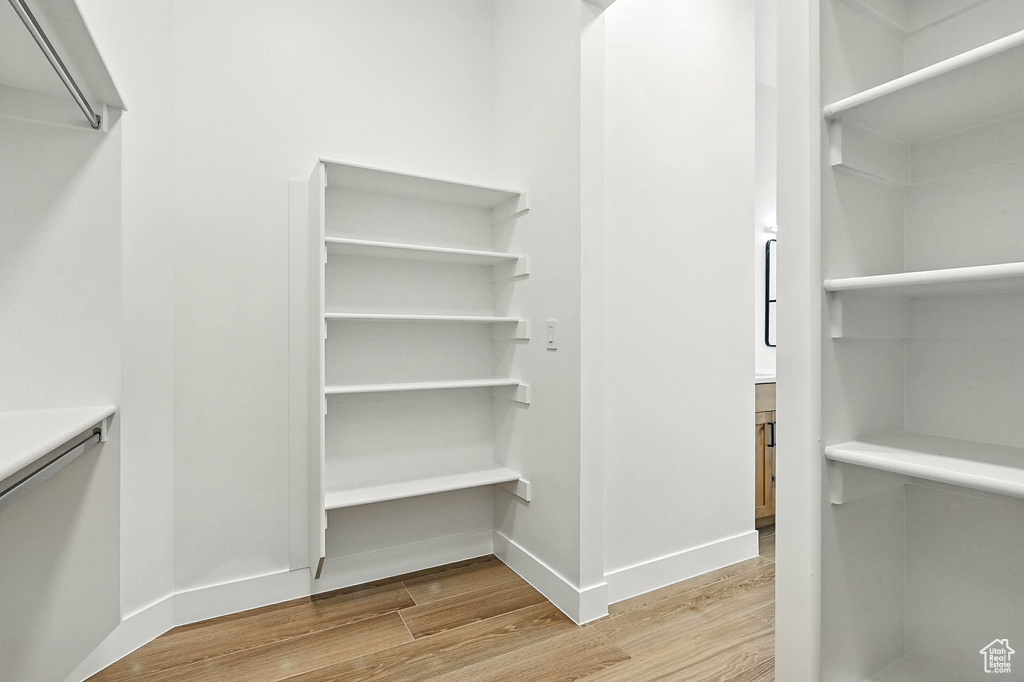 Spacious closet featuring wood finished floors