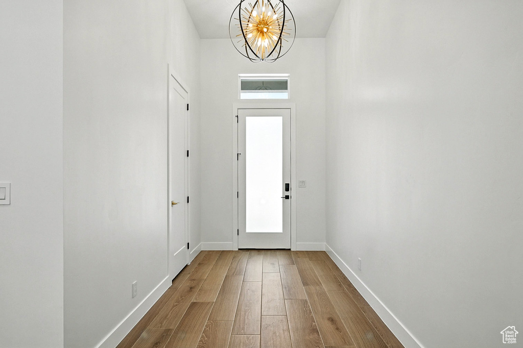 Entrance foyer with a chandelier and wood finished floors