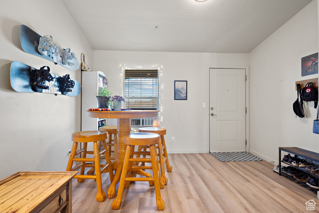 Dining area featuring light wood-style floors and baseboards