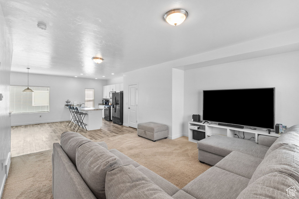 Living room featuring light colored carpet and recessed lighting