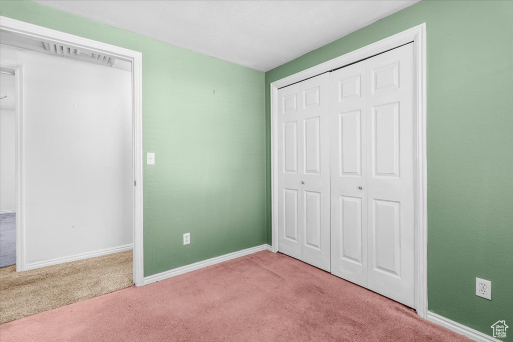 Unfurnished bedroom with carpet floors and a closet