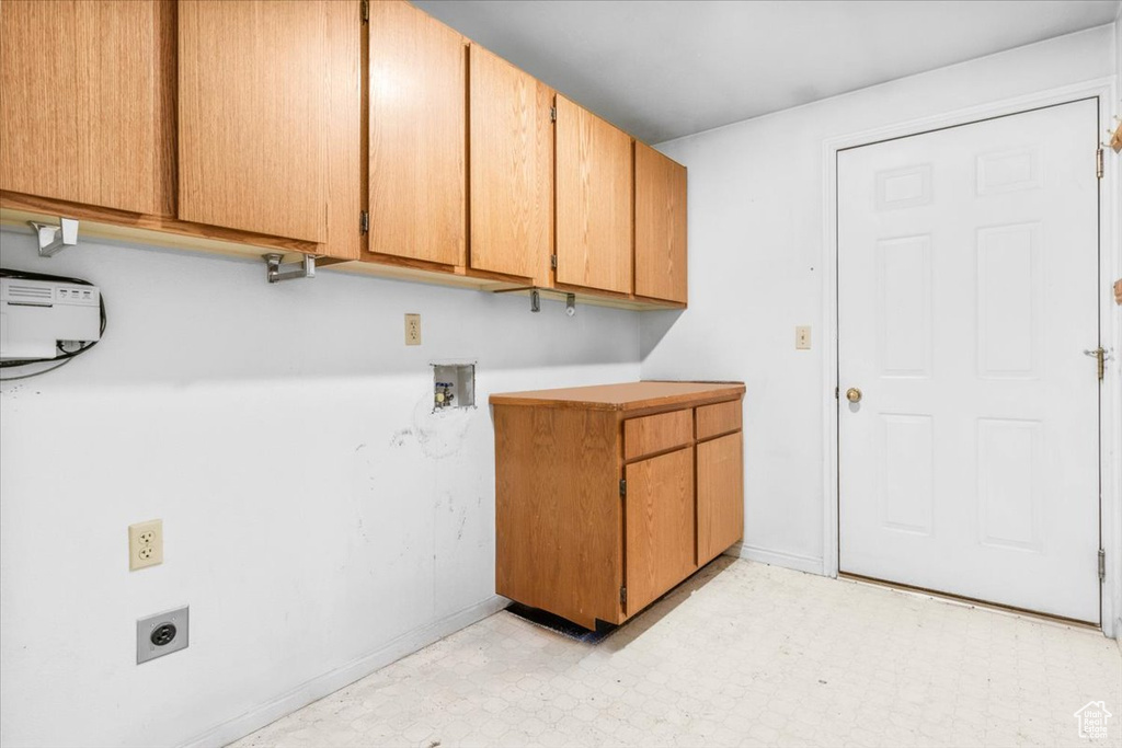 Laundry room with cabinet space, electric dryer hookup, light floors, and hookup for a washing machine