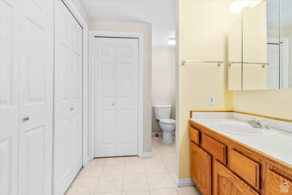 Full bath featuring a closet, vanity, and tile patterned floors