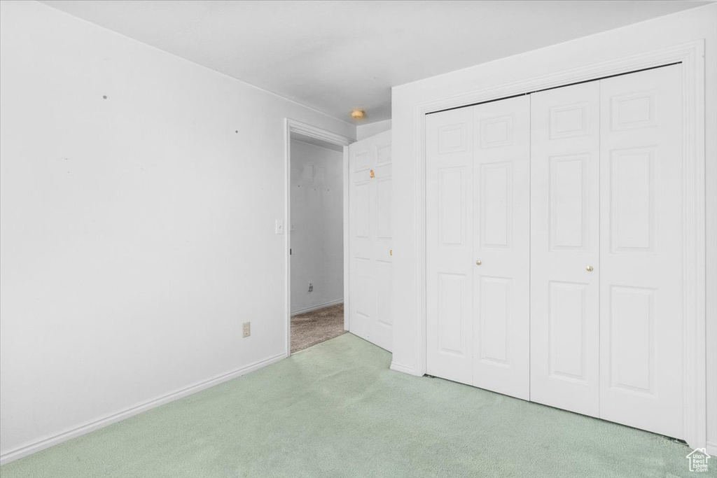 Unfurnished bedroom with carpet floors and a closet