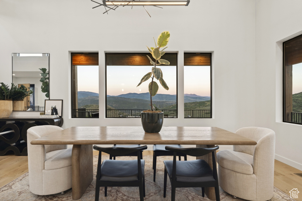 Dining room with light wood finished floors and a mountain view
