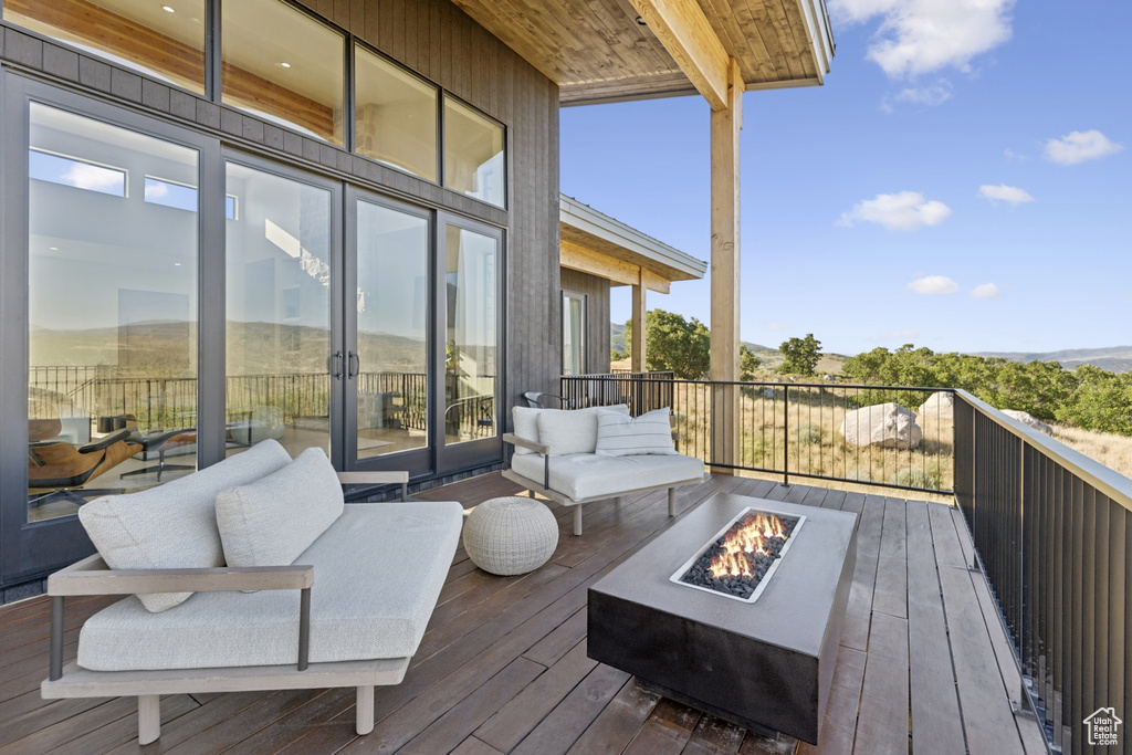 Wooden deck with an outdoor living space with a fire pit