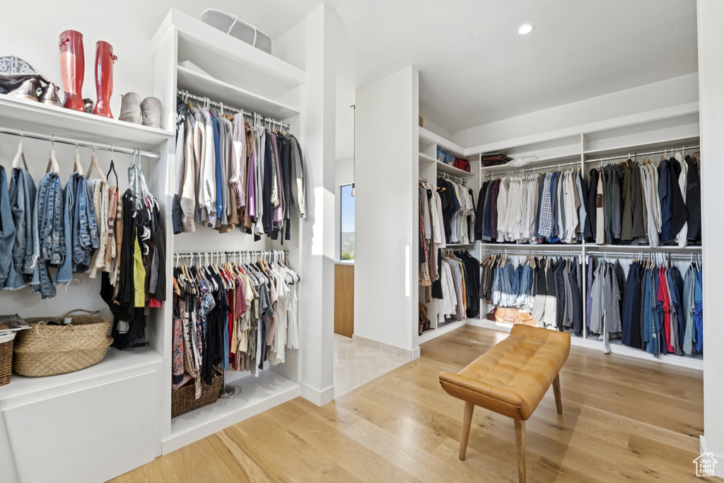 Walk in closet with wood finished floors