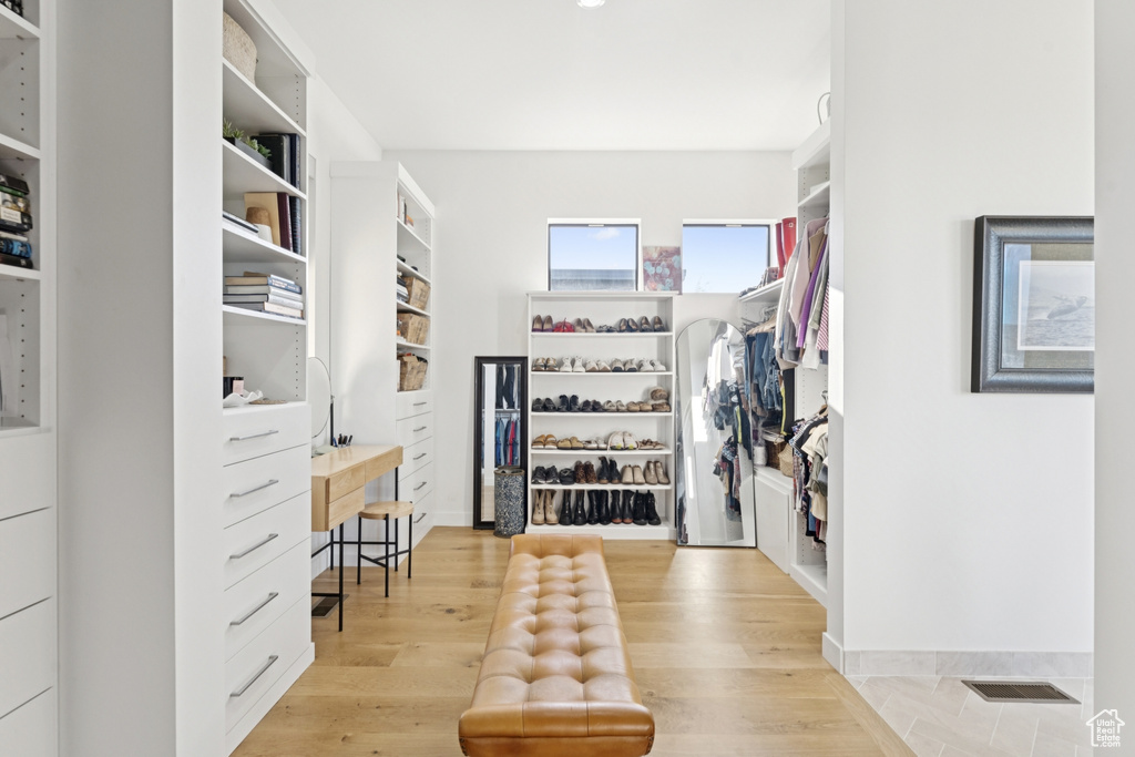 Spacious closet with light wood-style floors