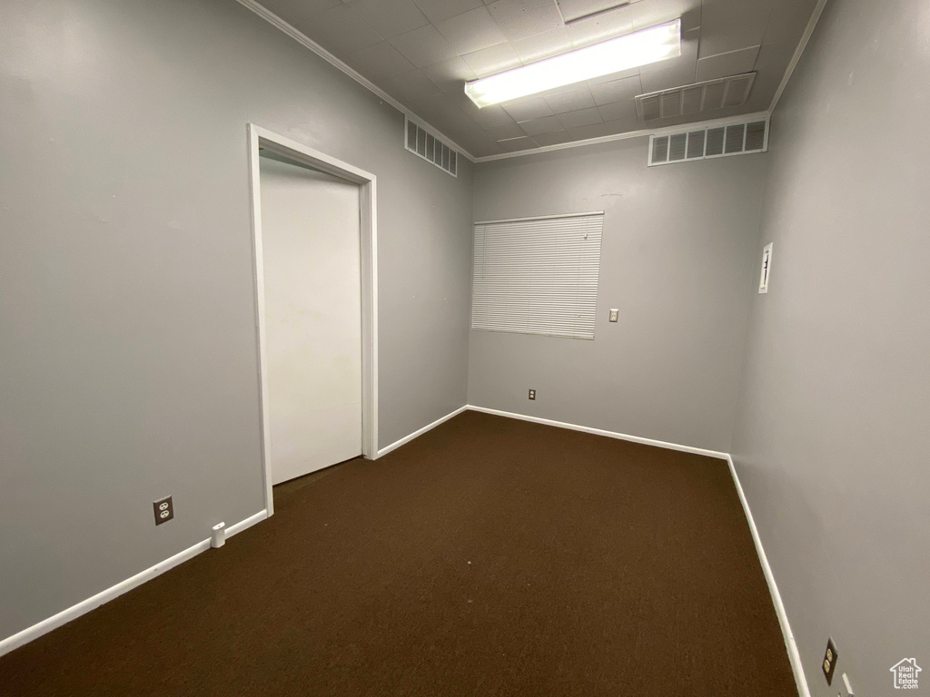 Empty room with dark colored carpet