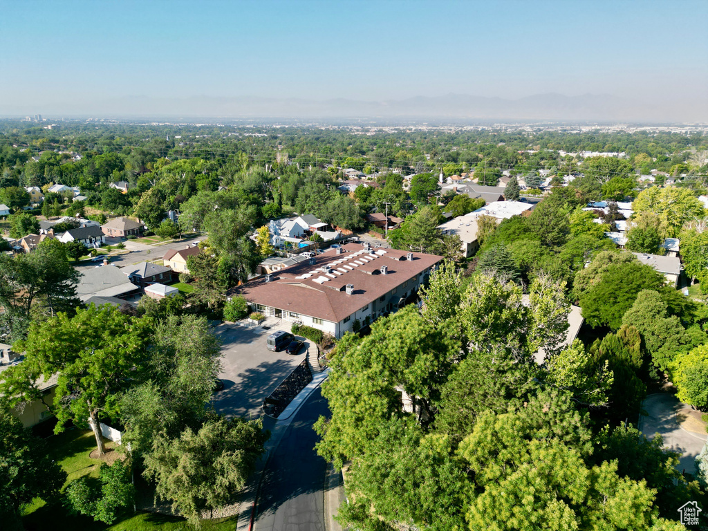 Aerial view of property and surrounding area featuring nearby suburban area