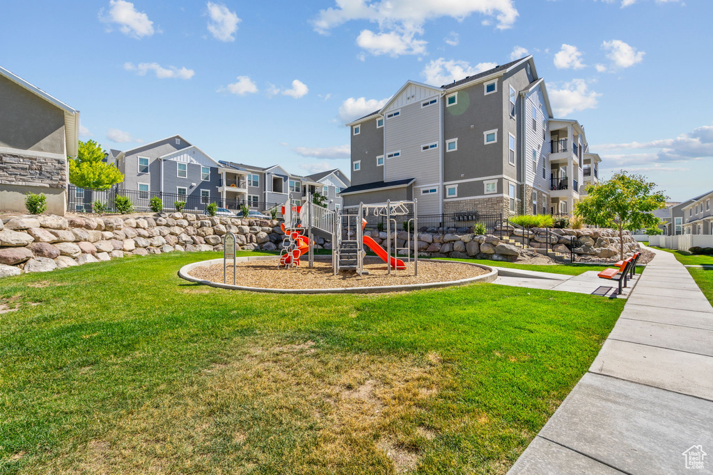 Community jungle gym featuring a residential view and a yard