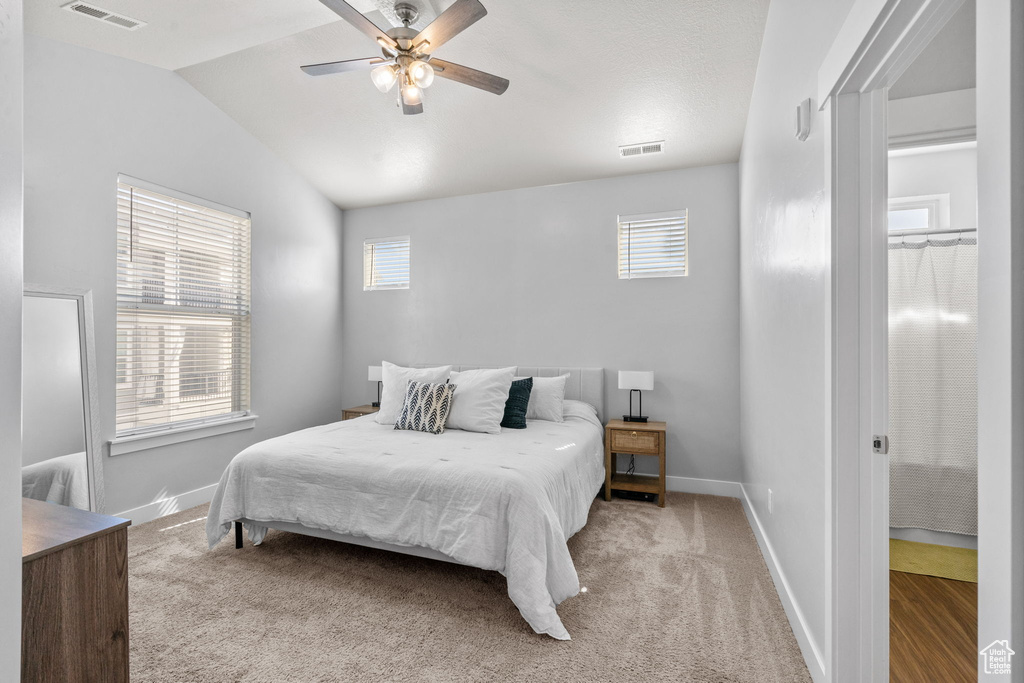 Bedroom featuring lofted ceiling, carpet floors, and ceiling fan