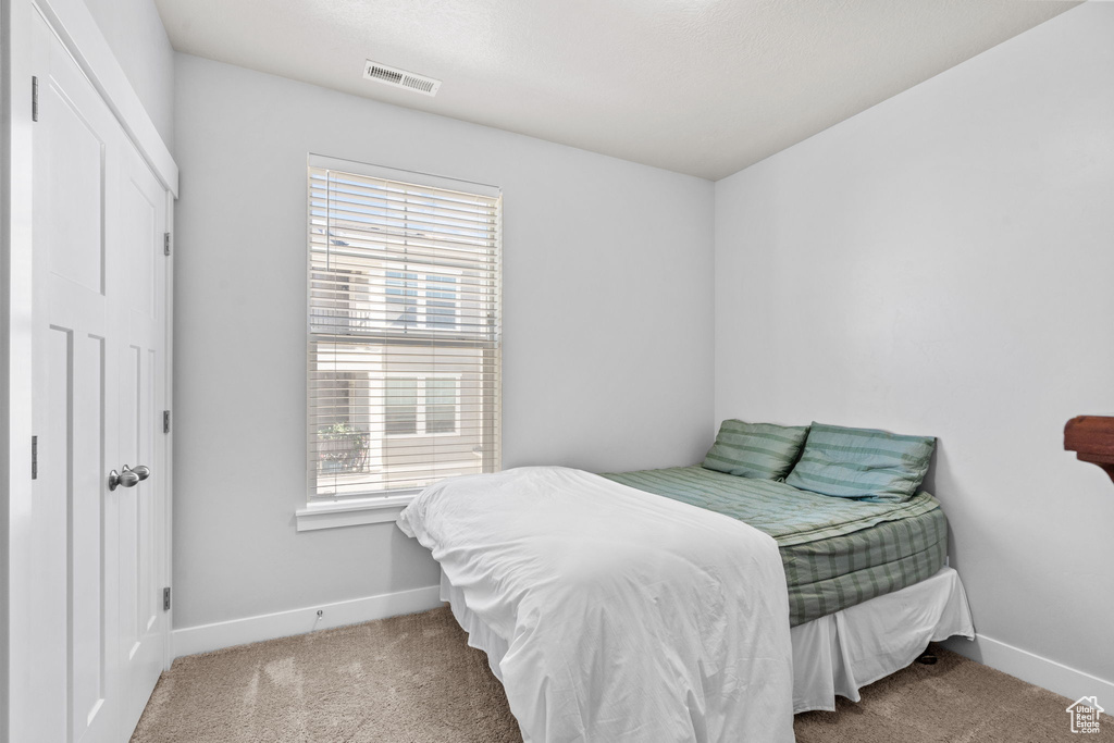 Carpeted bedroom with baseboards