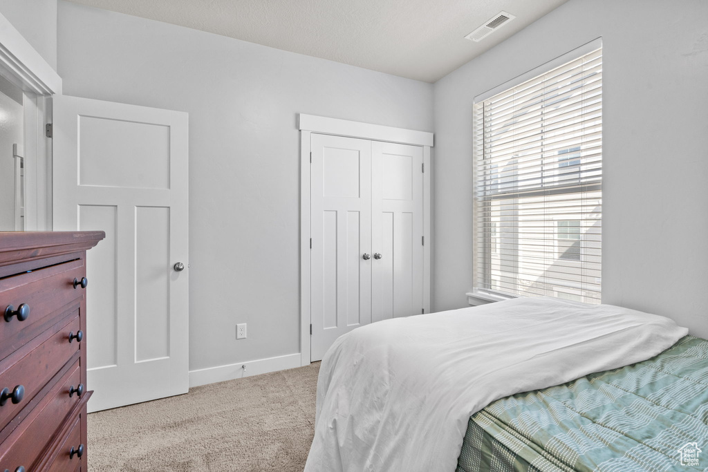 Bedroom with carpet flooring and a closet