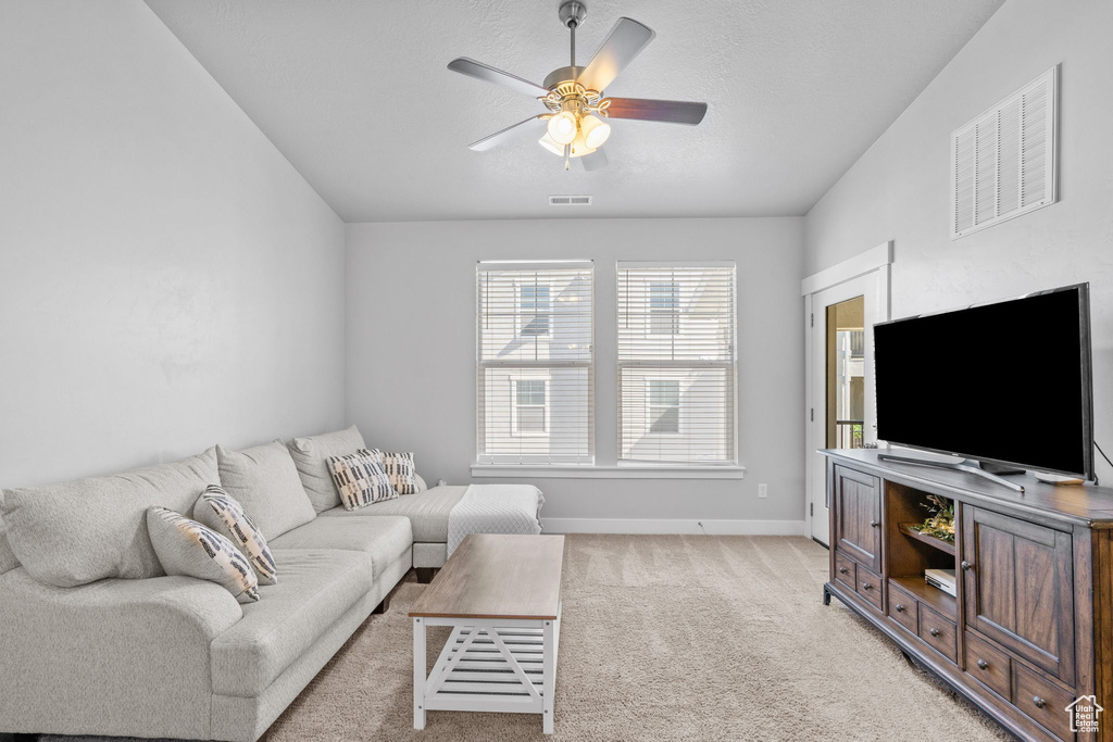 Living room featuring ceiling fan and light carpet
