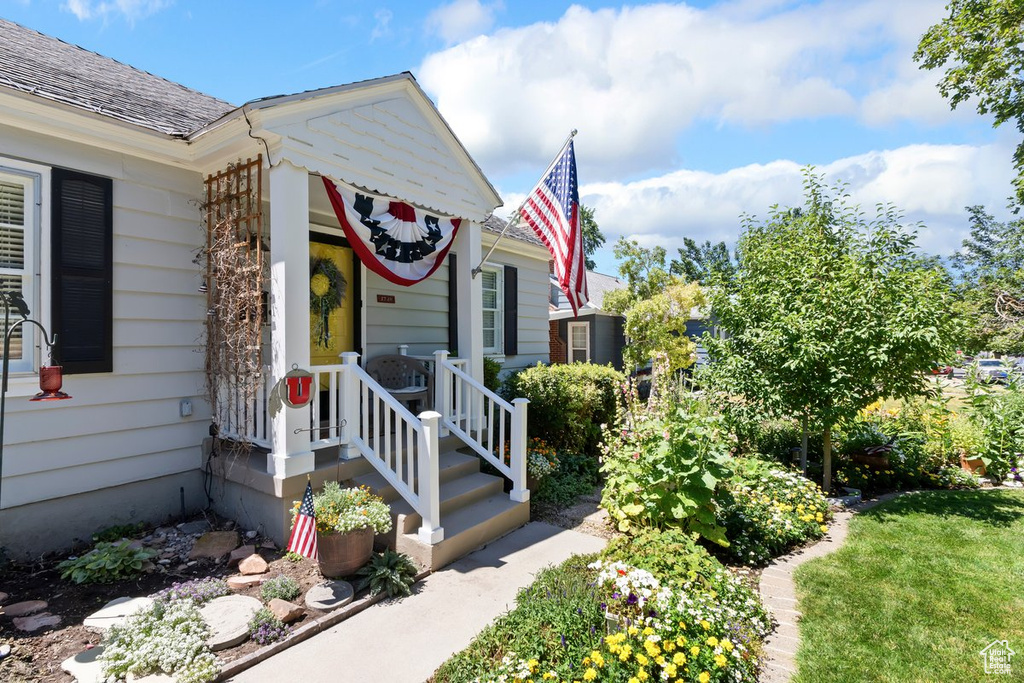Entrance to property with a shingled roof