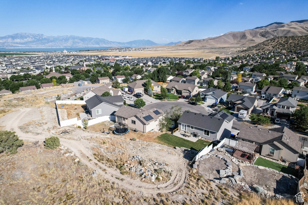 Aerial overview of property's location with mountains and nearby suburban area