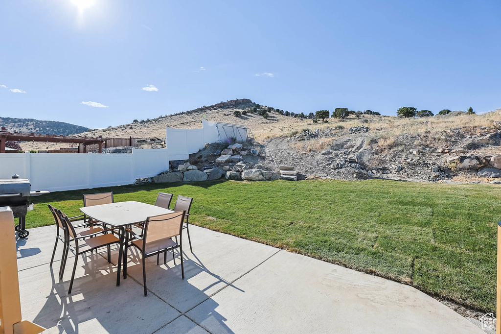 View of patio / terrace featuring a mountain view and outdoor dining space