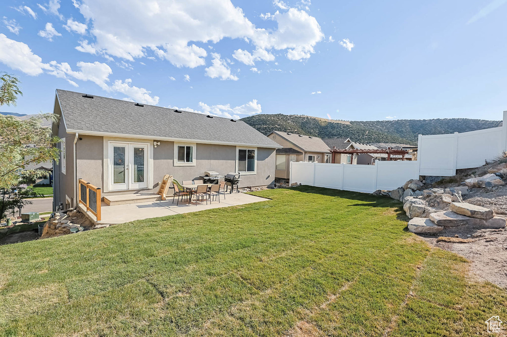 Back of house with french doors, a patio, a shingled roof, and stucco siding