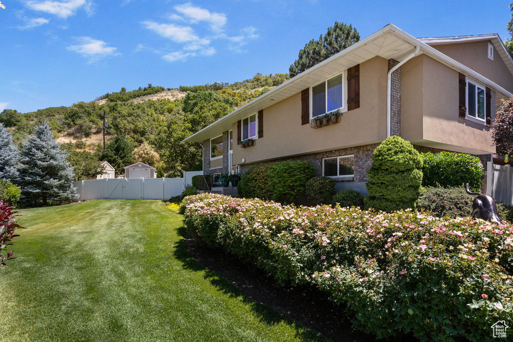 View of side of property featuring stucco siding and brick siding