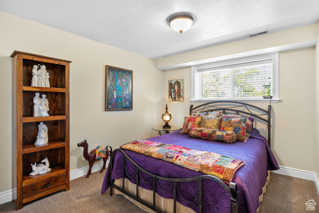 Bedroom featuring carpet flooring and baseboards
