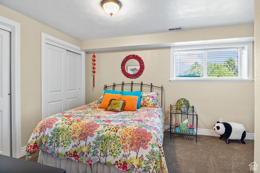 Bedroom with carpet floors and a closet