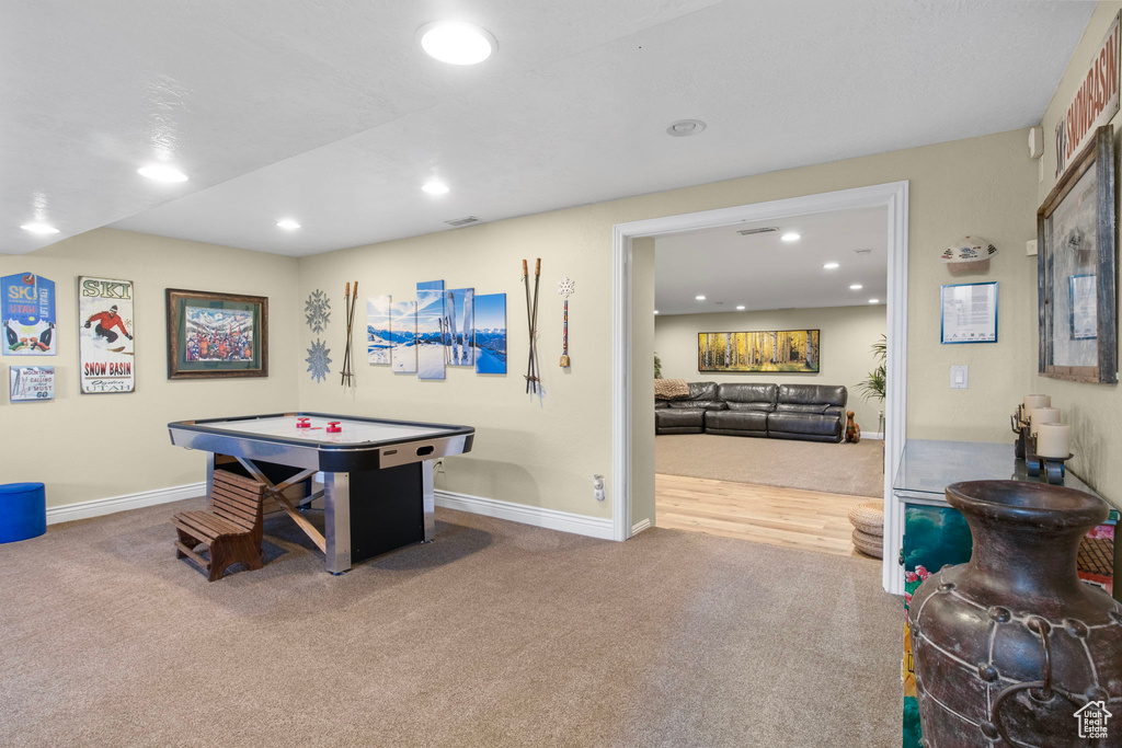 Recreation room with carpet floors and recessed lighting