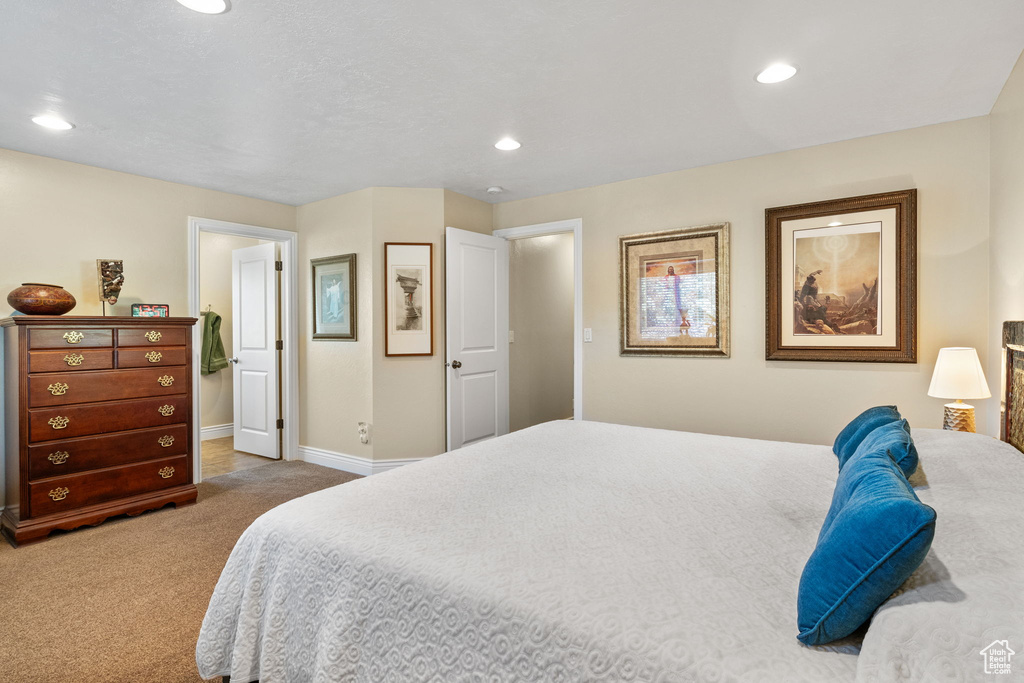 Carpeted bedroom with baseboards and recessed lighting