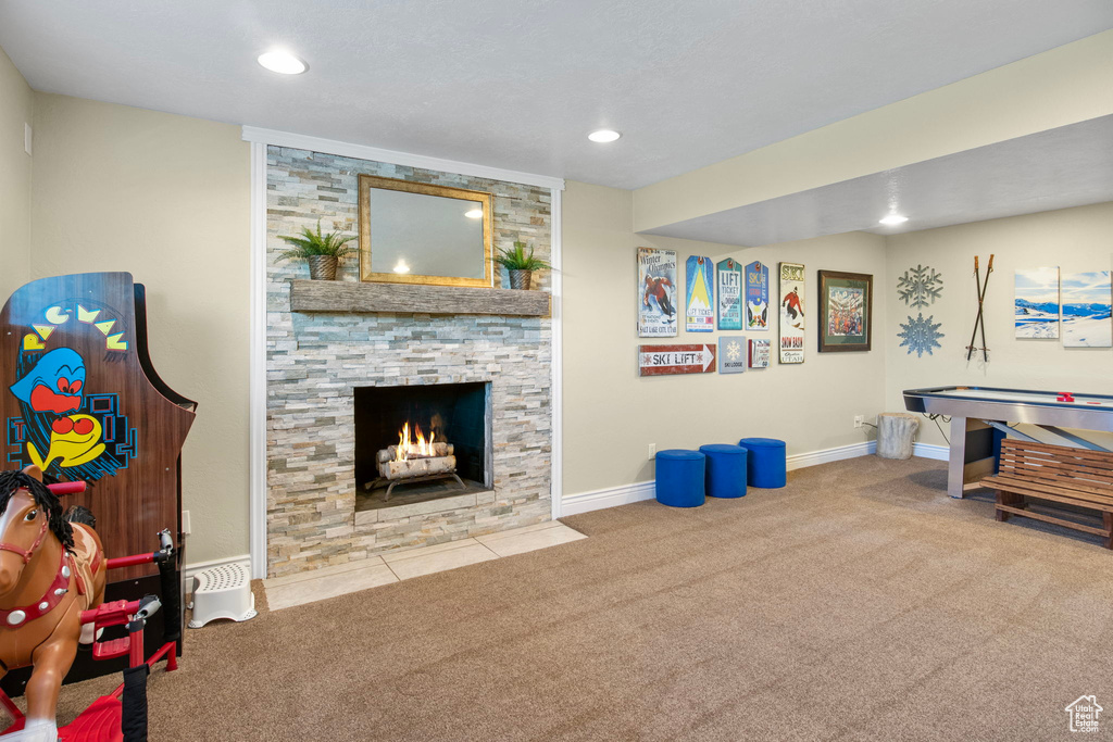 Living area featuring carpet, recessed lighting, and a fireplace