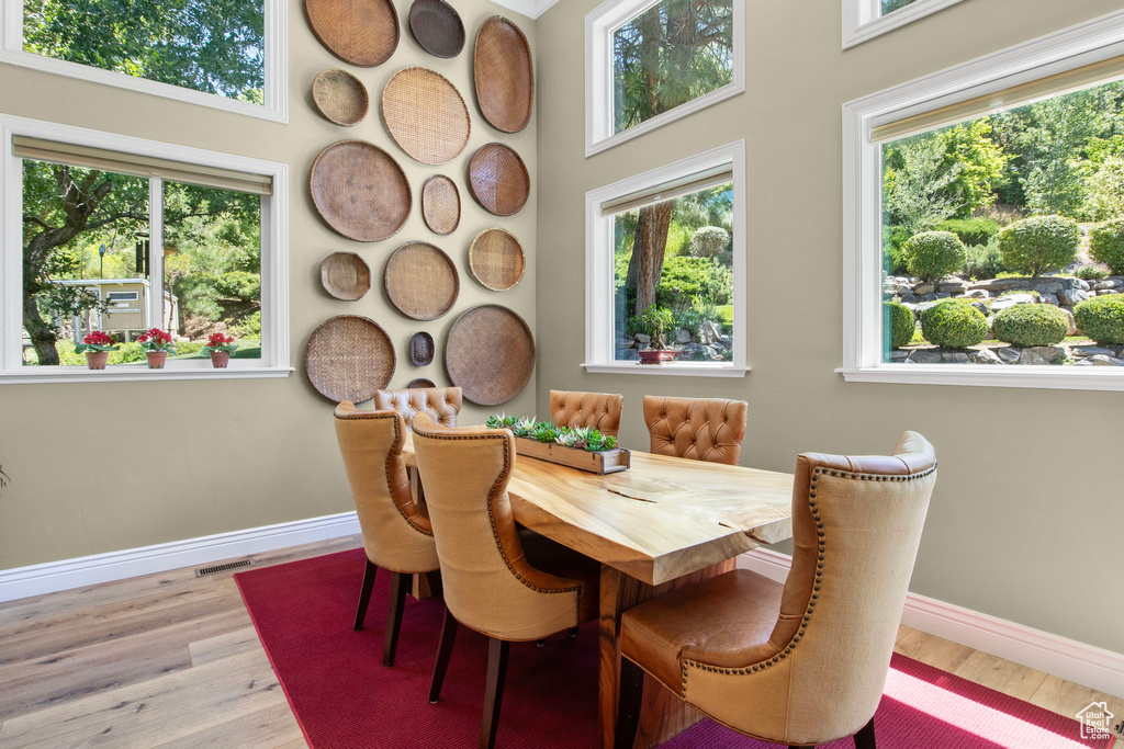 Dining room with wood finished floors and plenty of natural light