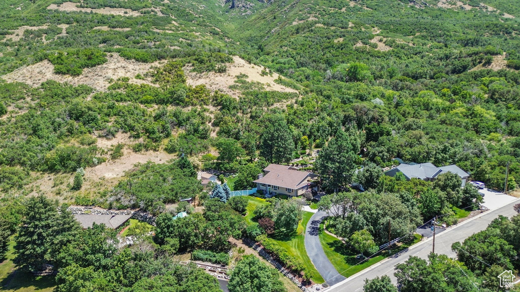 View of property location featuring a forest