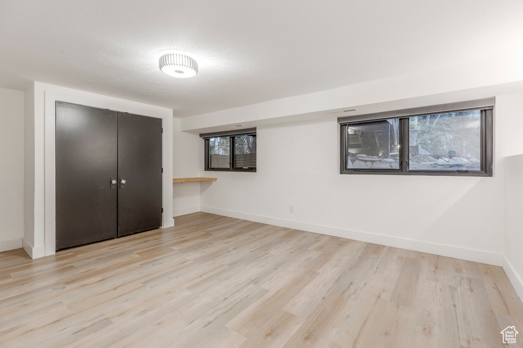 Unfurnished bedroom with light wood-style floors and a closet
