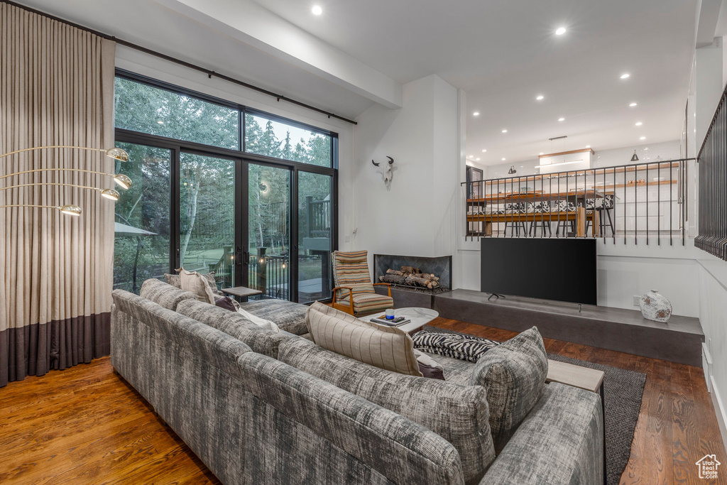 Living area with recessed lighting, a fireplace, and wood finished floors