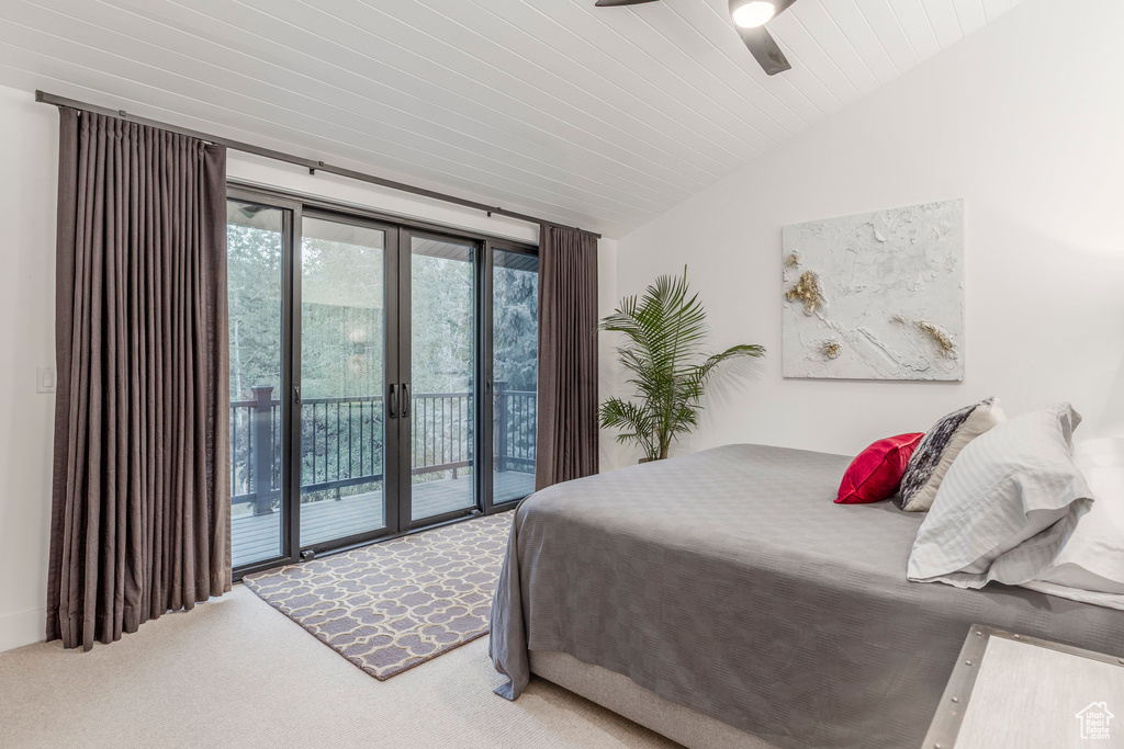 Bedroom featuring access to outside, carpet, vaulted ceiling, french doors, and ceiling fan