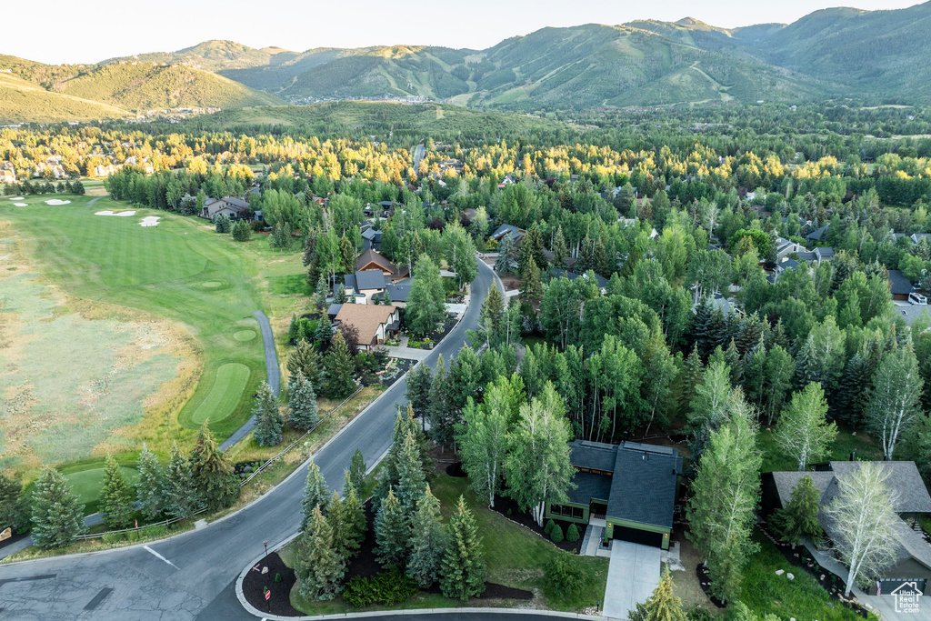 Bird's eye view of a mountainous background and a golf course