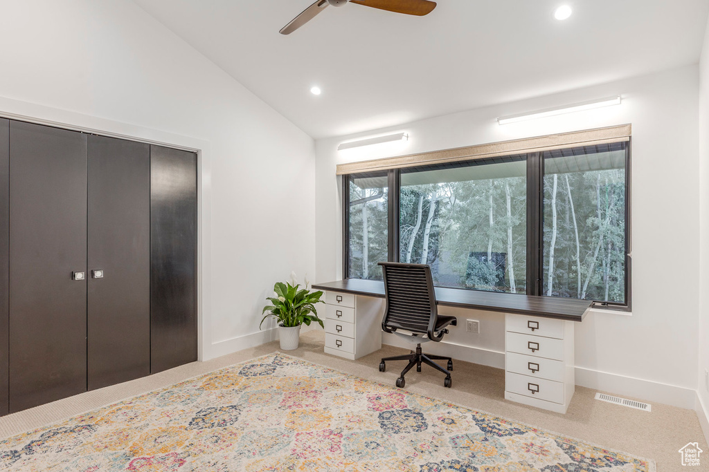Carpeted home office with a ceiling fan, lofted ceiling, recessed lighting, and built in desk