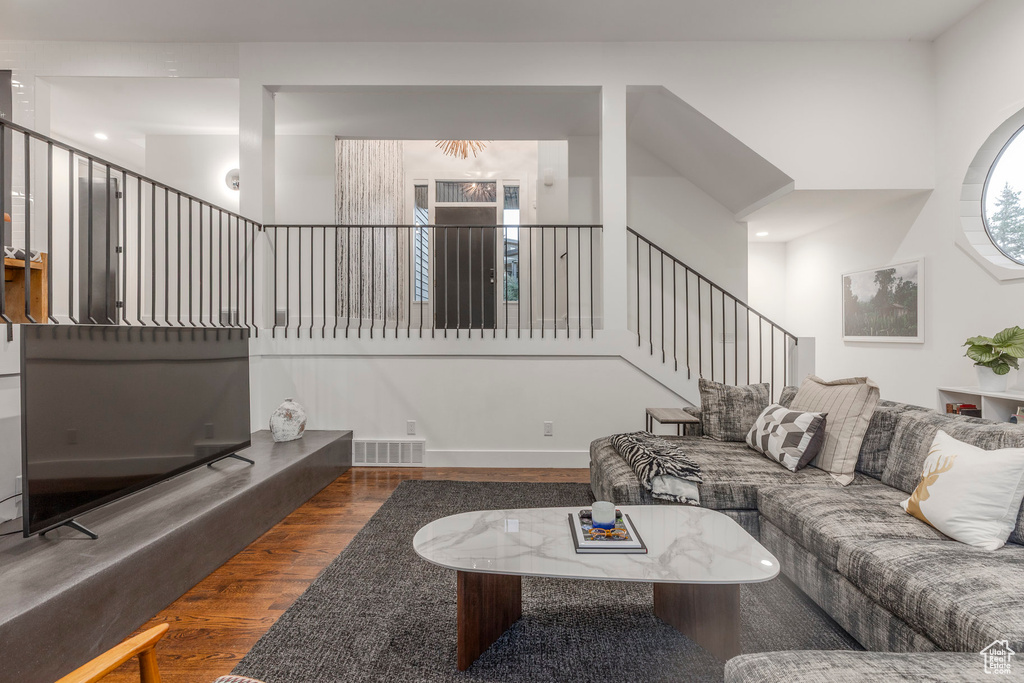 Living room with wood finished floors and stairs