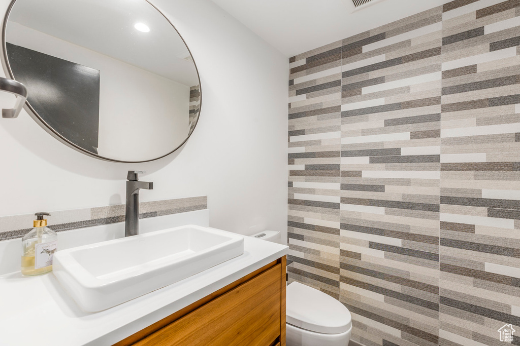 Half bathroom with toilet and vanity