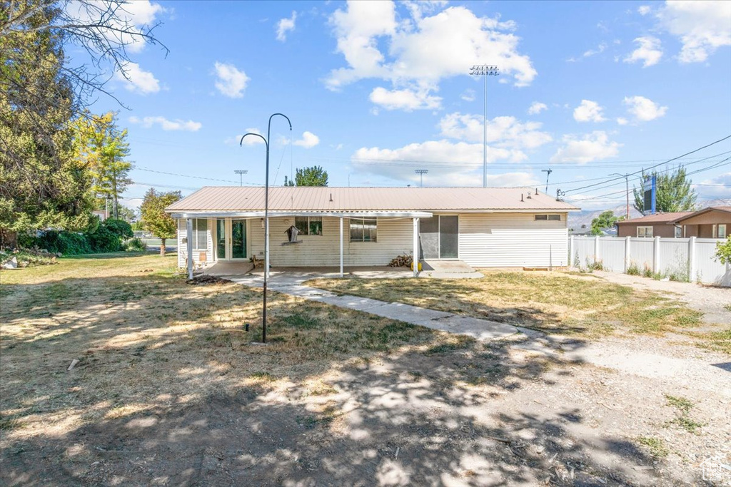 Back of property featuring a metal roof and a patio