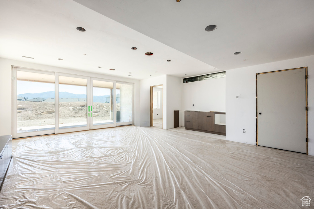 Unfurnished living room featuring a mountain view