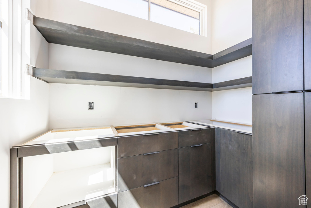 Kitchen featuring open shelves and dark brown cabinetry