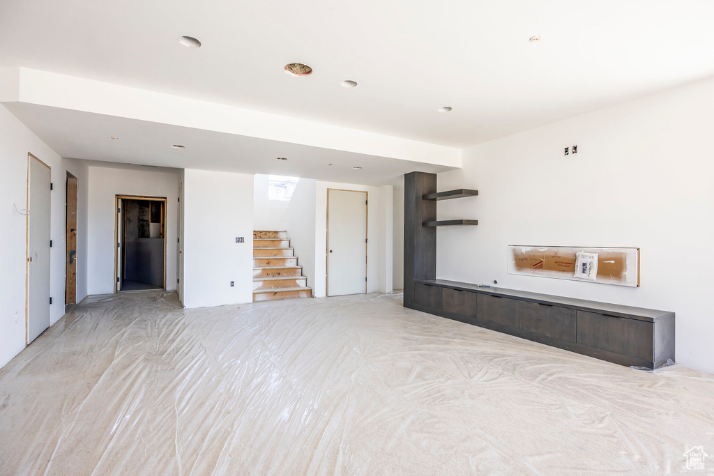 Unfurnished room with stairs and recessed lighting