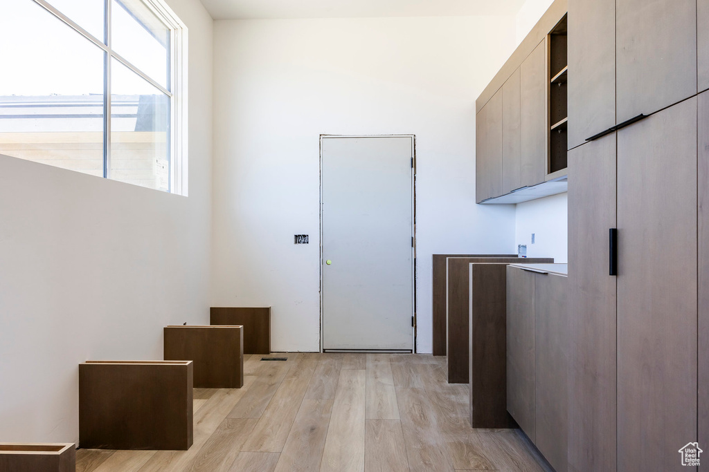 Corridor featuring light wood-style flooring