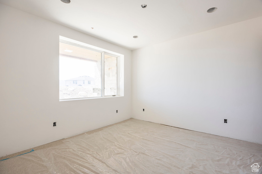 Unfurnished room featuring light carpet