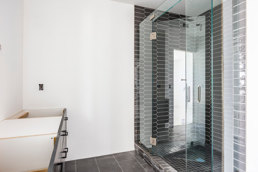 Full bathroom with a shower stall, tile patterned floors, and vanity