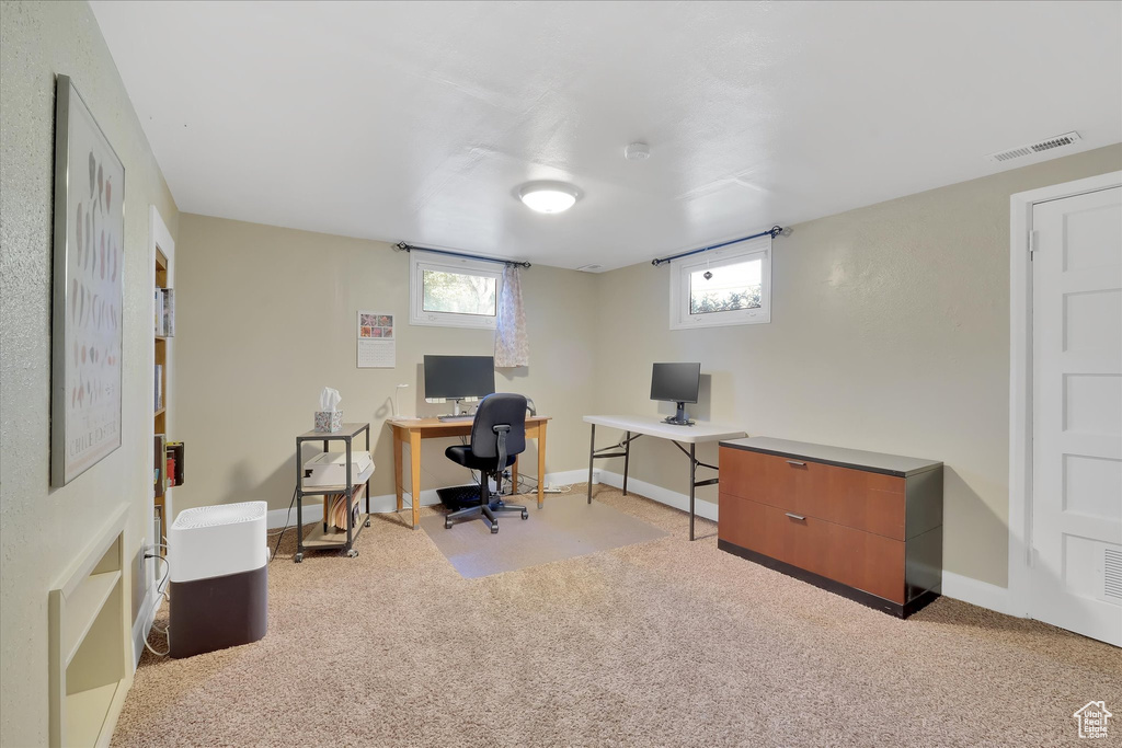 Carpeted office space featuring baseboards