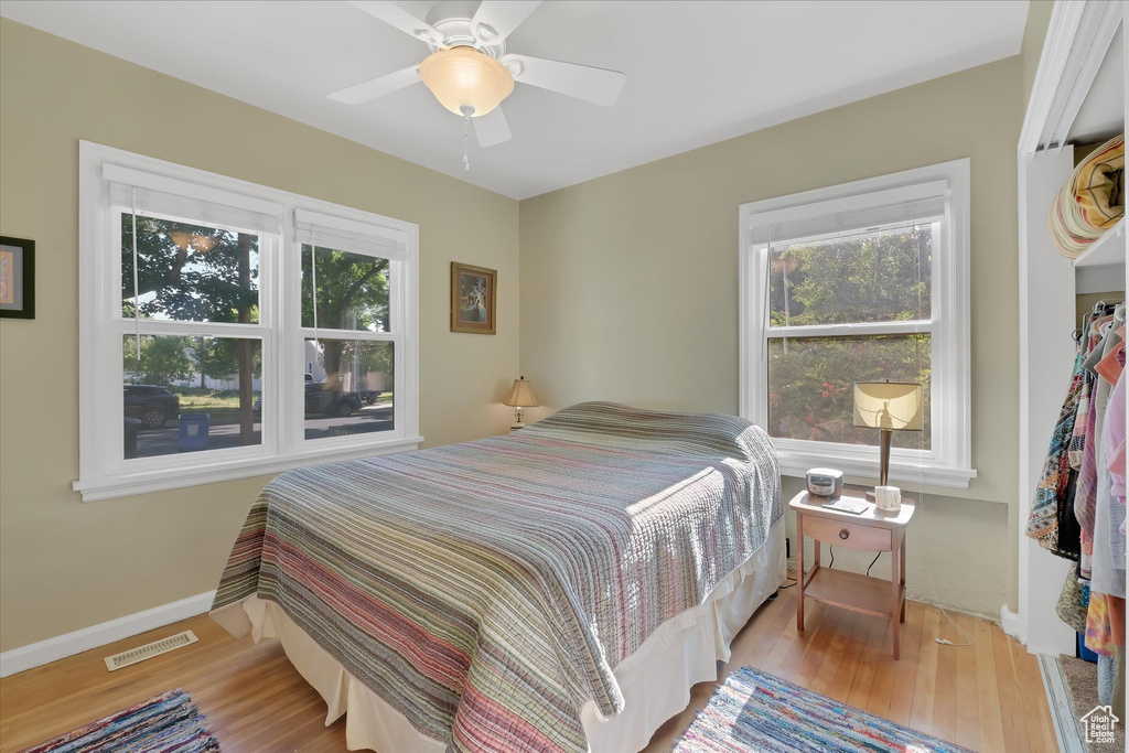 Bedroom with wood finished floors and a ceiling fan