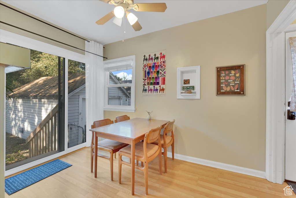 Dining room featuring wood finished floors and ceiling fan