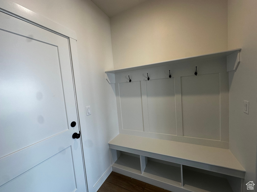 Mudroom with dark wood-style floors and baseboards