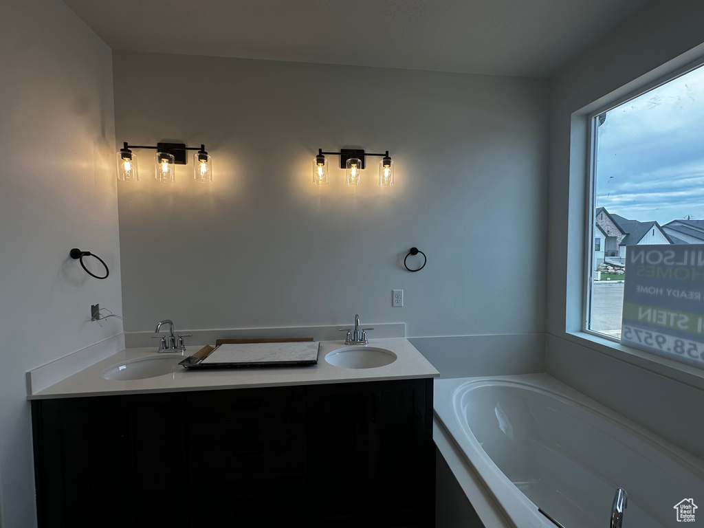 Bathroom with a bath and double vanity